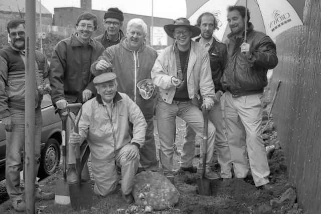 1989: These gents from Mansfield Lions Club brave the rain while doing a spot of bulb planting in the community. Did you take part in this?