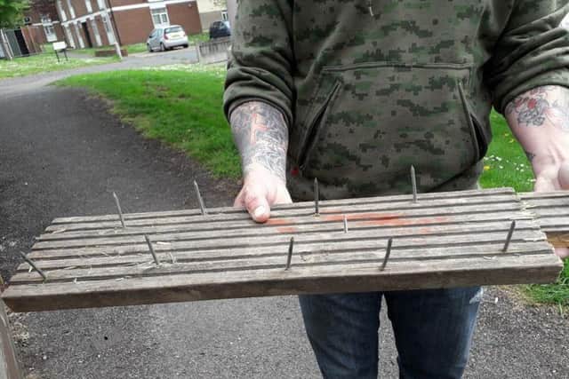 A concerned resident shared a picture of a plank of wood, which has nails sticking upwards.