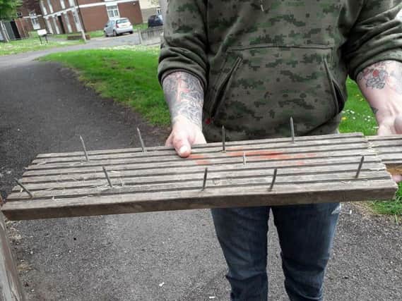 A concerned resident shared a picture of a plank of wood, which has nails sticking upwards.