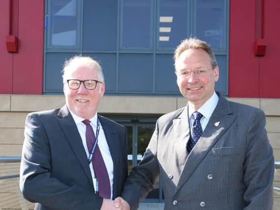 Chair of governors Sean Lyons (left) congratulates Andrew Cropley on his appointment.