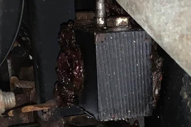A broken bolt on the ice machine carriage