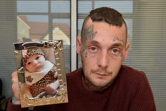 Dean Bird with a picture of his murdered daughter Eve Leatherland.