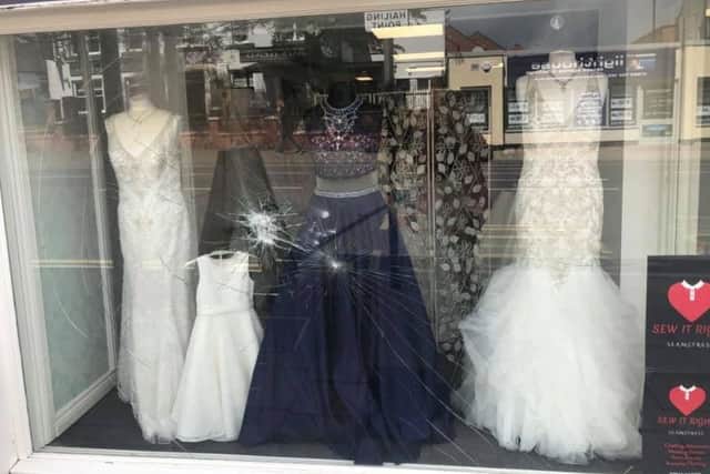 The bridal dresses in the window were covered with shards of broken glass.