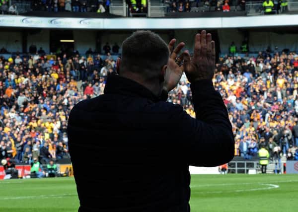 Mansfield Town v Milton Keynes.
David Flitcroft applauds the visiting fans at the start of the match.