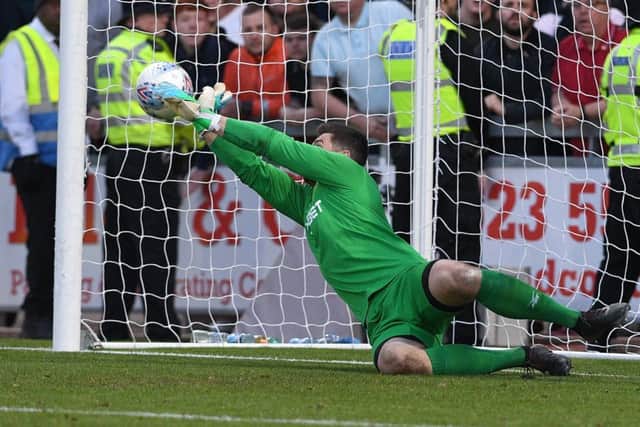 Newport's Joe Day saves the crucial penalty which resulted in his side winning.