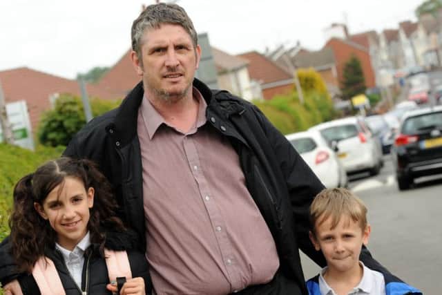 Richard Houghton with his son Thomas seven, and step daughter Alaexandra Shopska, 11 outside the Flying High Academy on Sommersall Street which is often the scene of thoughtless parking.