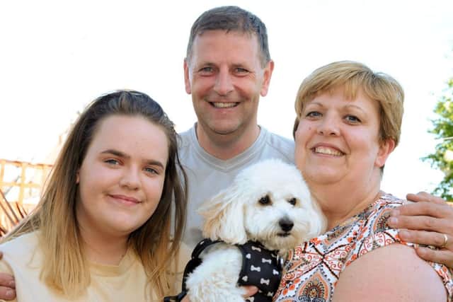 Mick Bonser who has been involved in Vicky McClure's Dementia Choir pictured with his wife Karen, daughter Hannah and assistance dog Benji.