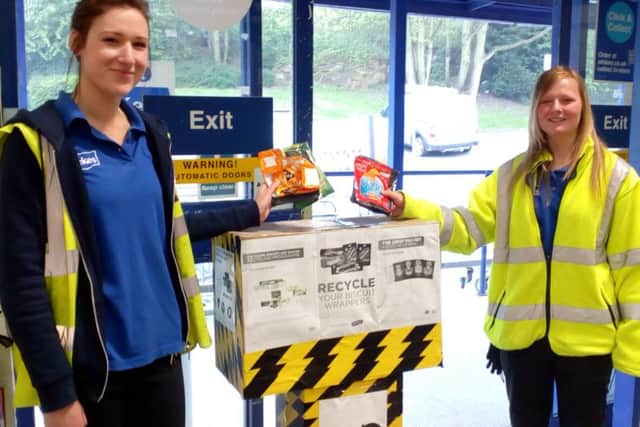 Leah Hughes and Jen Burton from Wickes putting the schools crisp packets into the Wickes collection box.