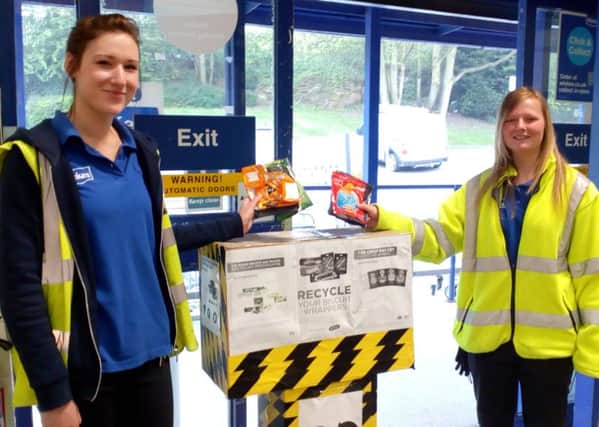 Leah Hughes and Jen Burton from Wickes putting the schools crisp packets into the Wickes collection box.