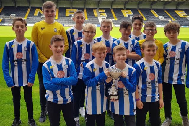 Champions Warsop Athletic U12s with their trophy at Meadow Lane.