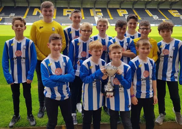 Champions Warsop Athletic U12s with their trophy at Meadow Lane.