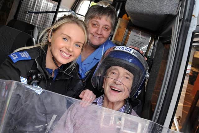 Norman Pickles, a resident at the Lowmoor Road Care Home, gets kitted out in riot gear when the police visited on Monday, also pictured are PCSO Sarah Keightley and senior care assistant Beverley Hannant.
