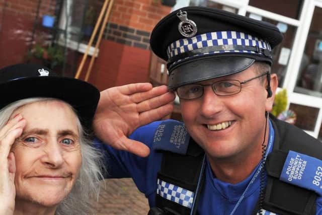 Jean Bagley and PCSO Sephen Shaw share a salute during a visit to the Lowmoor Road Care Home on Monday.
