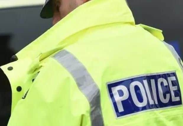 The pensioner was left injured after the men forced their way into her home.