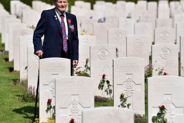 British veteran John Prior looks at the graves of fallen British soldiers during a Service of Remembrance at the Commonwealth War Graves Cemetery in Bayeux, Normandy, northwestern France, on June 6, 2019 as part of D-Day commemorations marking the 75th anniversary of the World War II Allied landings in Normandy. (Photo by Ben STANSALL / AFP) (Photo credit should read BEN STANSALL/AFP/Getty Images)