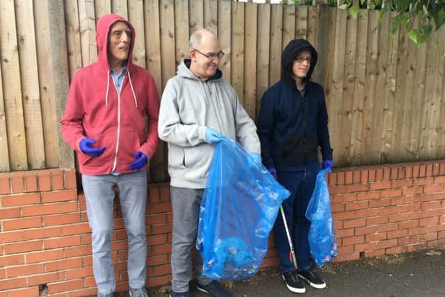 Corner House residents, from left, David Calladine, aged 63, Tony Topley, 57, and Warren Bailey, 36, taking part in the litter pick. Picture: Jon Ball.