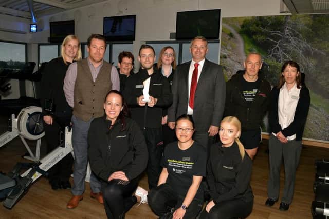 Senior duty manager Adam Spooner holding the award with Councillor Andy Burgin And Leisure Centre team
