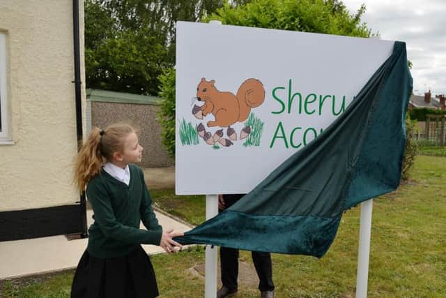 Official opening of Sherwood Junior School nurture unit, pupil Elizabeth Harrison, 11 unveils the new sign she designed.