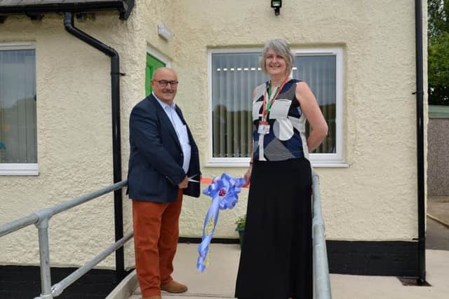 Official opening of Sherwood Junior School nurture unit, John Fretwell cuts the ribbon with executive headteacher Helen Atkins.