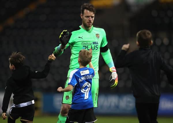 Adam Collin of Notts County celebrates with young supporters during The Emirates FA Cup Fourth Round match between Notts County and Swansea City at Meadow Lane on January 27, 2018 in Nottingham, England.  (Photo by Clive Mason/Getty Images)