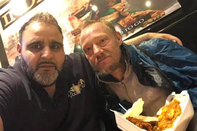 Mr Zaman with a homeless customer.
