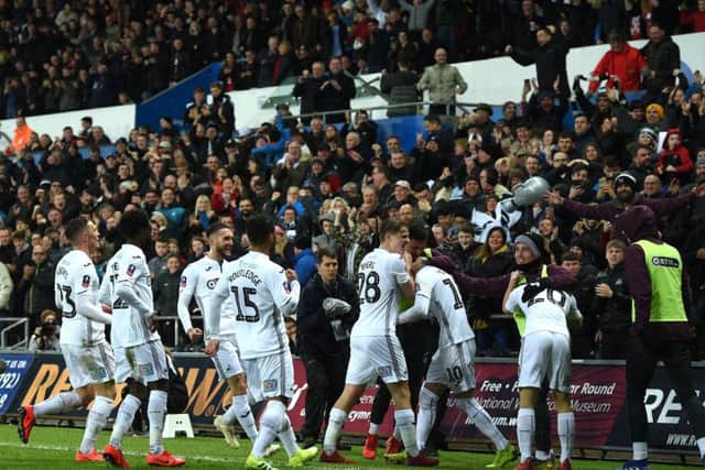 Swansea City celebrate after scoring their second goal against Manchester City at The Liberty Stadium on 16th March.