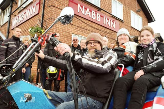 Mike and Sam Hart with their daughter, get aboard their trike for a trip to Matlock to fulfill Sam's wish.