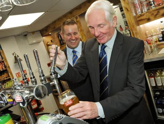 Stags legend Sandy Pate, pulls a pint at the newly refurbish Sandy's Bar and Kitchen with bar manager, Jonathan Redfearn.