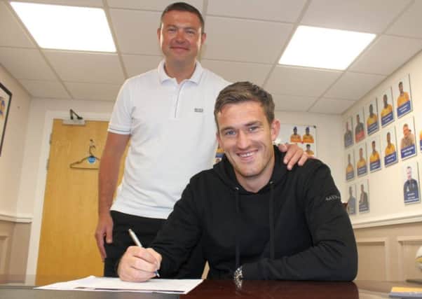 Andy Cook signs for John Dempster on Friday.
