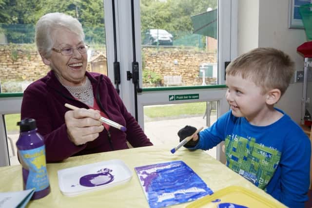 George Jackson makes his Father's Day card with resident Brenda Smith.