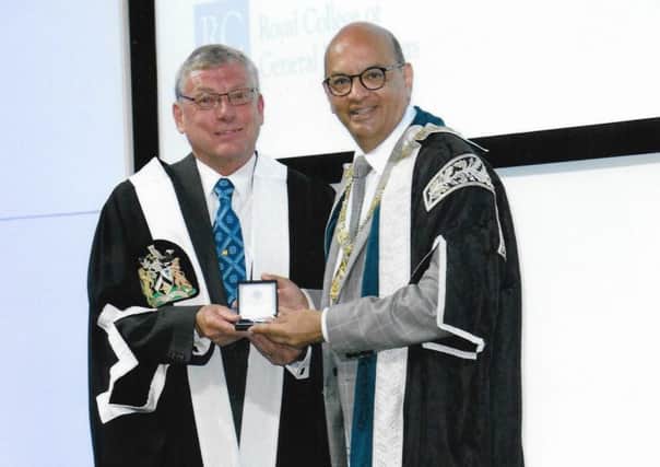 Dr Kevin Hill (left) receives the Presidents Medal of the Royal College of General Practitioners from its president, Professor Mayur Lakhani.