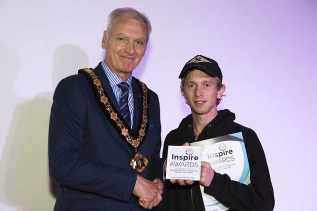 Joseph Hales receives his adult learner of the year award from Coun Kevin Rostance.