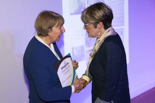 Fiona Theokritoff receives a certificate from Coun Kay Cutts as a finalist in the tutor of the year category.