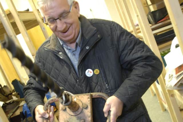 Retired miner Eric Eaton handles a drill he would have used as a chargeman ripper at Newstead Colliery.
