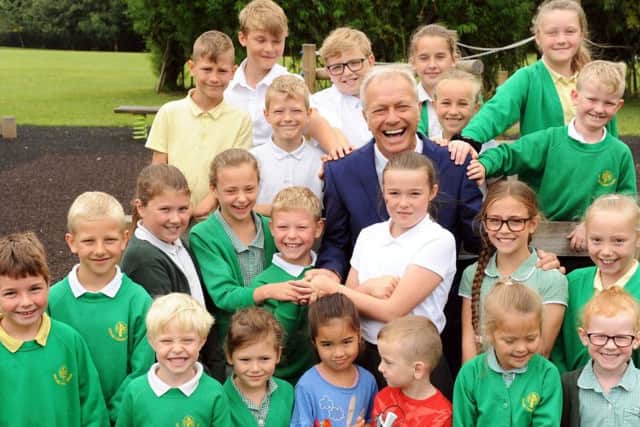 Orchard Primary and Nursery School's head teacher Rob Cook is pictured with some of his pupils before retiring after 13 years at the school.