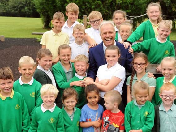 Orchard Primary and Nursery School's head teacher Rob Cook is pictured with some of his pupils before retiring after 13 years at the school.