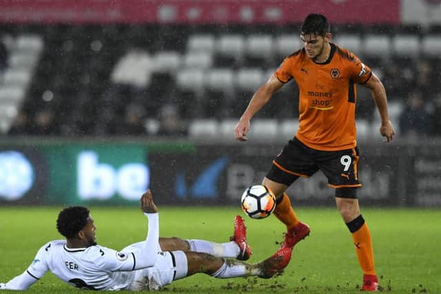 SWANSEA, WALES - JANUARY 17: Leroy Fer of Swansea City tackles Rafa Mir of Wolverhampton Wanderers during The Emirates FA Cup Third Round Replay between Swansea City and Wolverhampton Wanderers at Liberty Stadium on January 17, 2018 in Swansea, Wales. (Photo by Stu Forster/Getty Images)