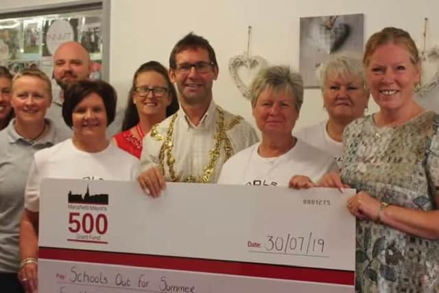 Members of The Peaceful Trust and Schools Out For Summer teams with Andy Abrahams, Mayor (Centre)
