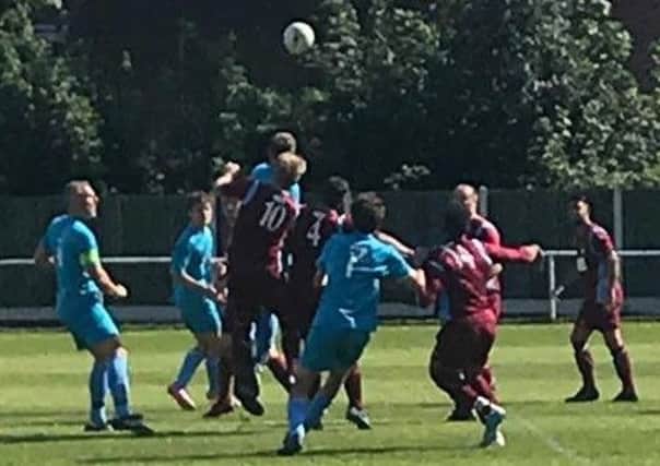 A tussle for a high ball in Clipstone's match at Radford. (PHOTO BY: Malc Holmes).