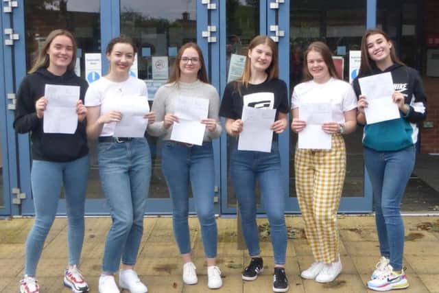 Pupils hold their results.