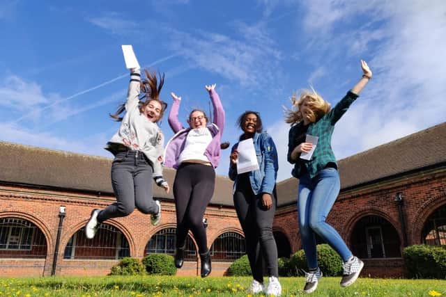 Students jump for joy at their results.