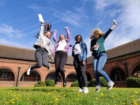 Students jump for joy at their results.