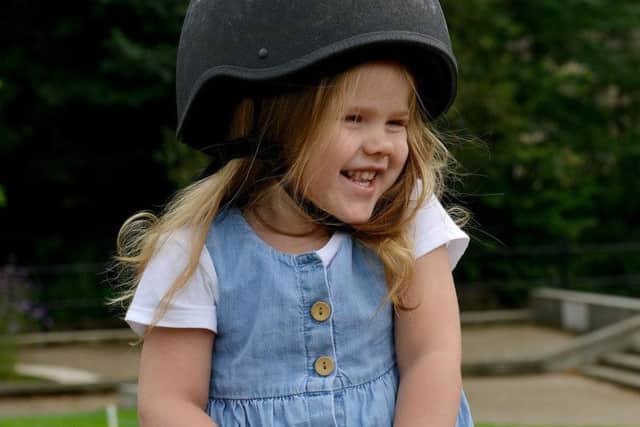 Poppy Easter, aged two, enjoys her first ride on a pony