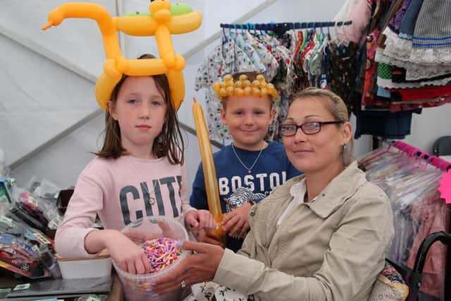 The Boulton family Kelsa-Mae, Finlay and mother Leanna have a go on the Scope tombola.