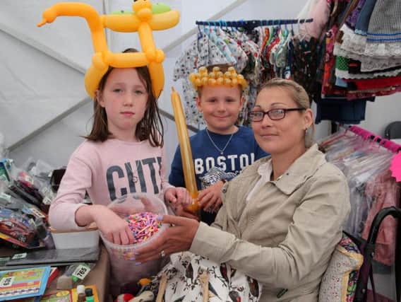 The Boulton family Kelsa-Mae, Finlay and mother Leanna have a go on the Scope tombola.