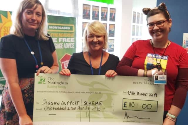 Bella Zygmunt (centre), presents the cheque for £110 to Alison Waring (left) and Amanda Wooley from Jigsaw Support Scheme.
