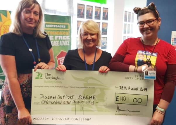 Bella Zygmunt (centre), presents the cheque for £110 to Alison Waring (left) and Amanda Wooley from Jigsaw Support Scheme.