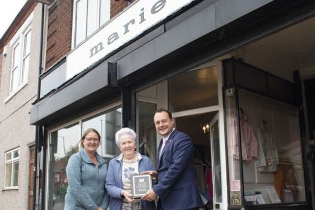 Ann Cooper (centre), the current owner of the Marie gown shop, receives her plaque from Coun Jason Zadrozny, leader of Ashfield District Council, and Coun Samantha Deakin.