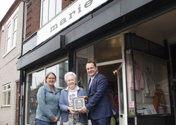 Ann Cooper (centre), the current owner of the Marie gown shop, receives her plaque from Coun Jason Zadrozny, leader of Ashfield District Council, and Coun Samantha Deakin.