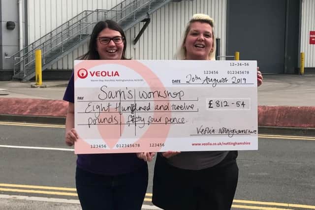 Representatives from Sam's Workplace in Rainworth proudly showing off the cheque they have received.